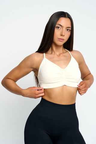 Stylish sports bra with ruched front and TRÄNA logo on the back