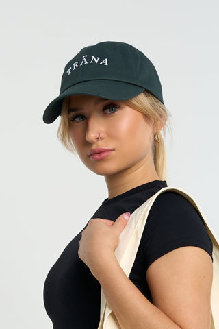 Cotton twill Träna cap in forest green with white logo embroidery