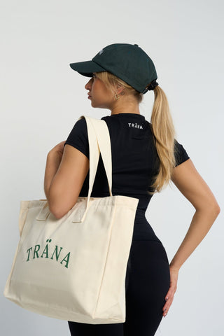 Versatile cream-colored gym tote bag made from durable canvas with spacious interior.